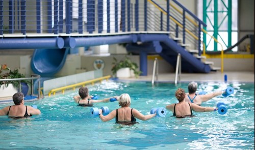 People attending an Aquacise class in a swimming pool.