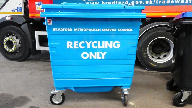 A large blue wheelie bin with 'Bradford Metropolitan District Council. Recycling only' on it