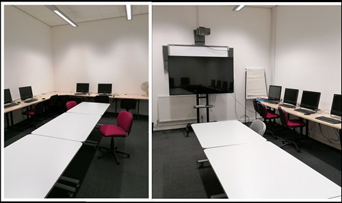 City Library meeting room with tables, chairs, computers and a large TV.