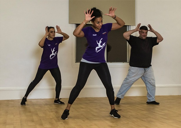 Three people taking part in a Movement class