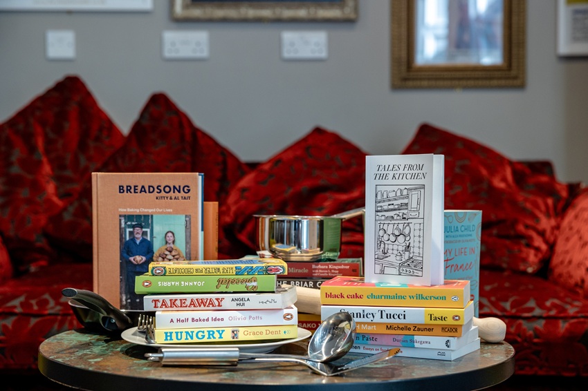 Big Tasty Read - a selection of books about food arranged on a table, with a red sofa in the background.